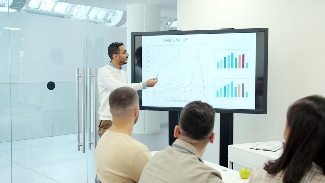 Digital signage ROI, presenting business case with financial data in a boardroom